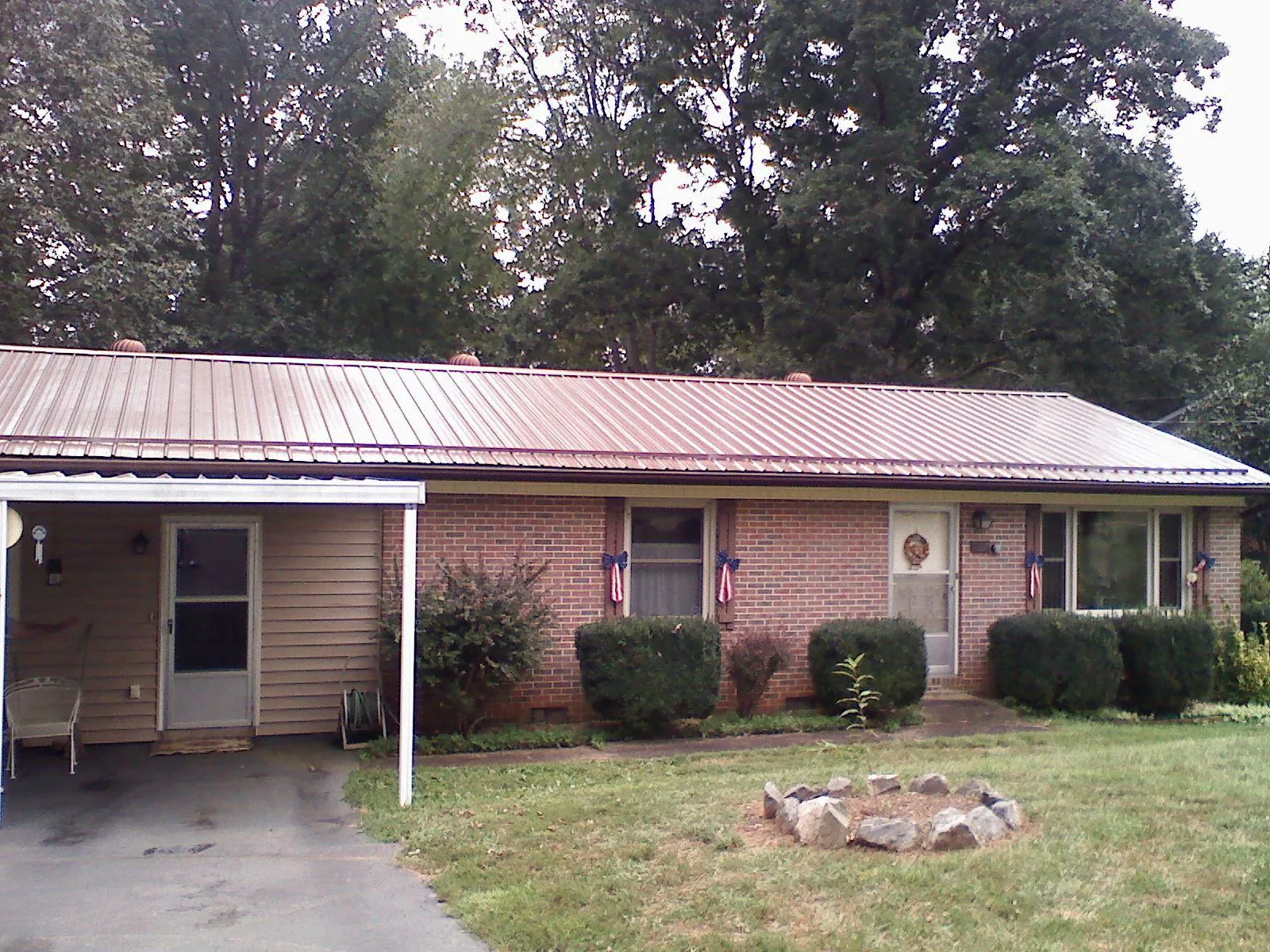 Bronze metal roof and carport on a brick ranch home — Roof Repair work by our crew in Pocasset