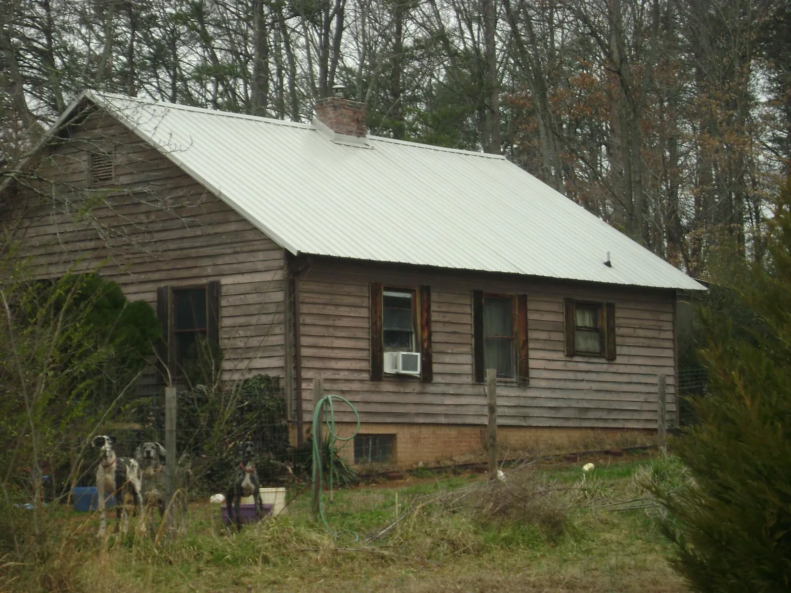 White metal roof on an old wood sided farmhouse, from a Metal Roof Installation job in Pocasset